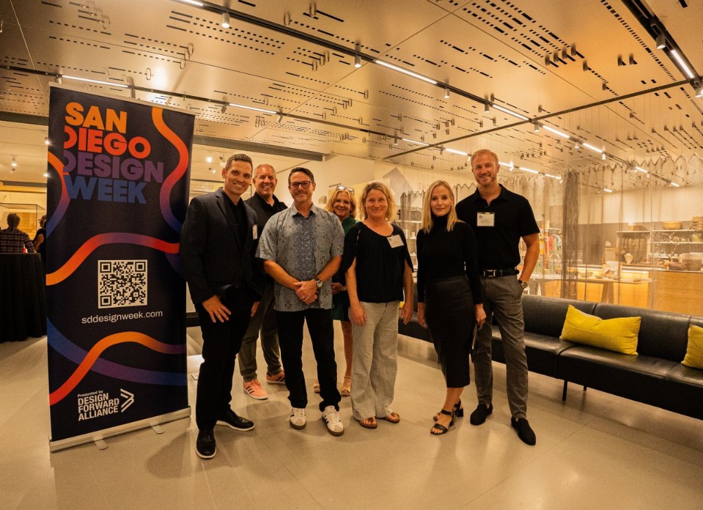 Event photo — team with SDDW pull-up banner and QR